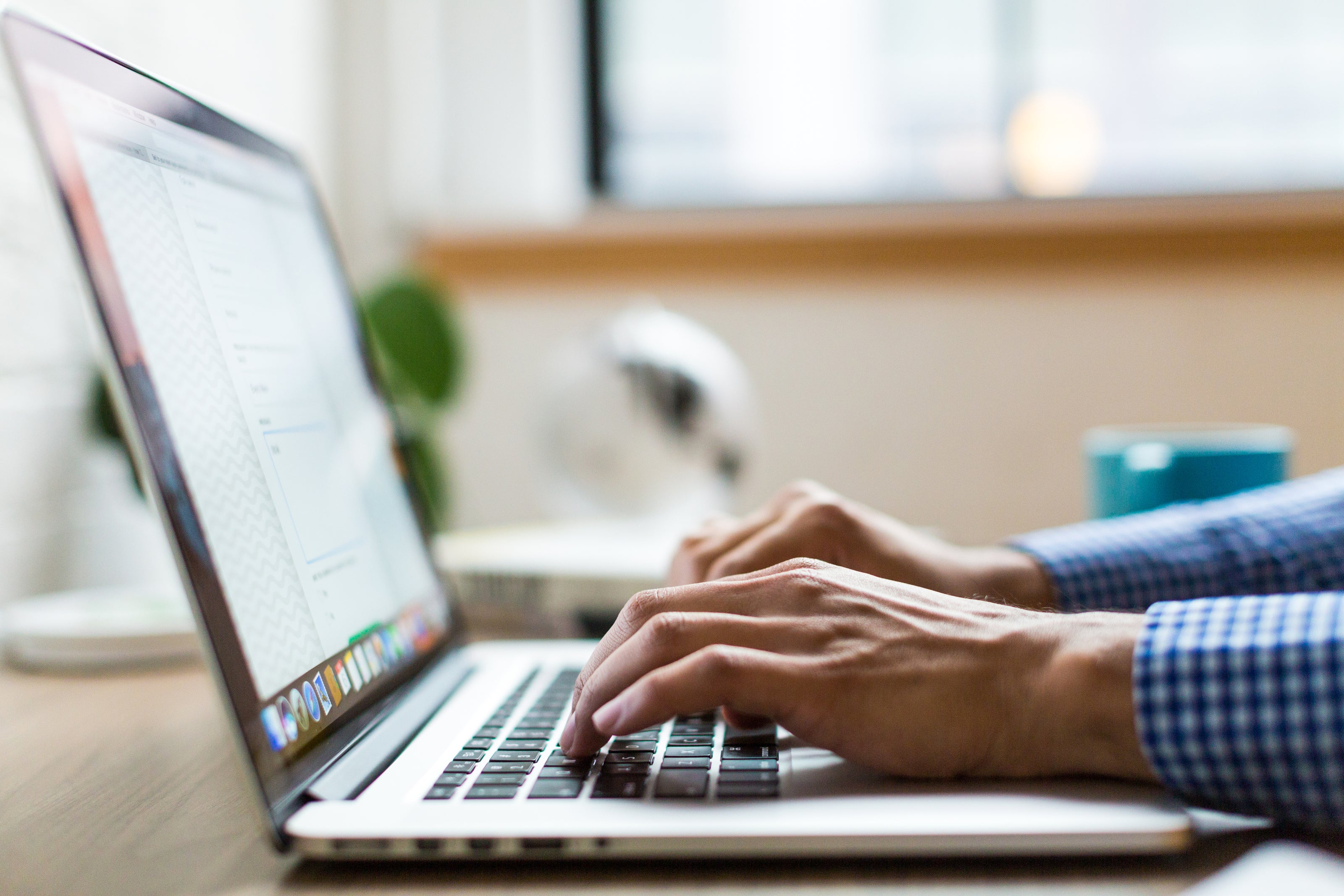 Image of a person typing on a laptop